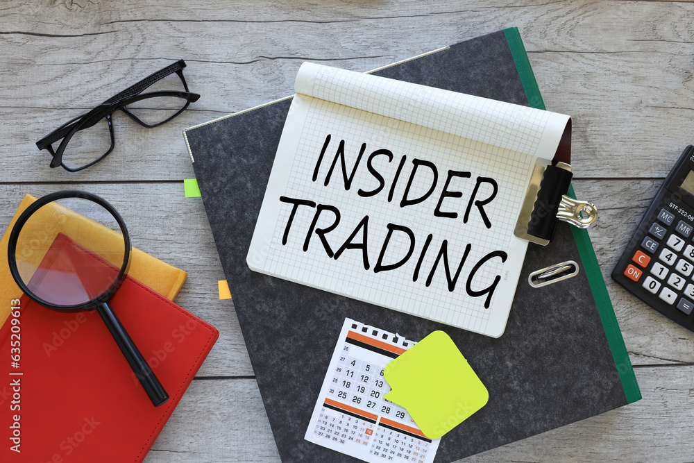 Poster insider trading text on a notebook on a folder. red notepad. magnifying glass