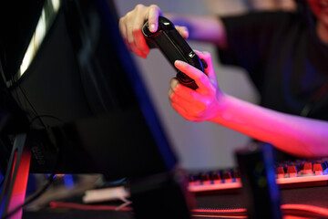  Hand holding game joystick playing online video games entertainment with pc at home.