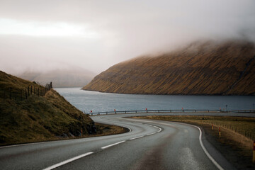 Curvy road in the mountains of  Faroe islands - 635212853