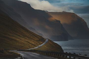 Car driving on scenic mountain road in Faroe islands - 635212863