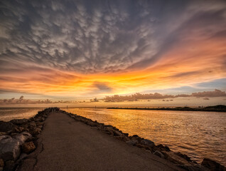 Sunset over the Gulf Intracoastal Waterway to the Gulf of Mexico from the Venice Jetty in Venice Florida USA