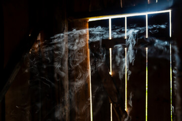 Abstract smoke in barn illuminated by sunlight