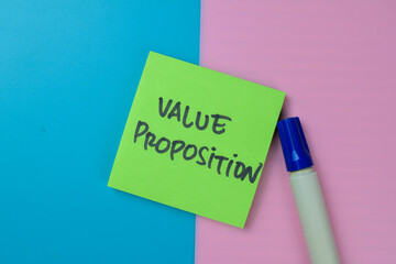 Concept of Value Proposition write on sticky notes isolated on Wooden Table.