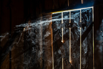 Abstract smoke in barn illuminated by sunlight © K