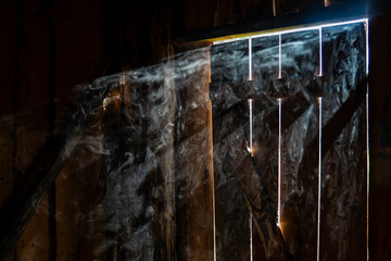 Smoke in the barn with sun rays shining through