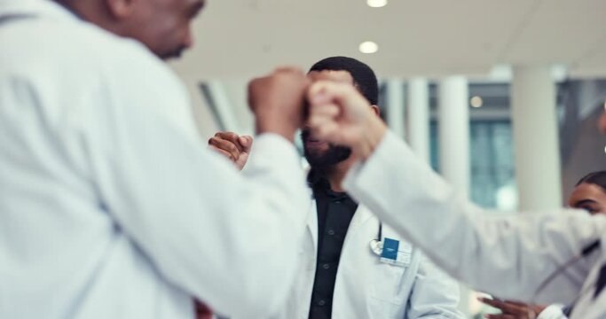 High five, fist bump and applause with a team of doctors in the hospital for success, support or motivation. Goals, target and teamwork with a professional medical group in a clinic for healthcare