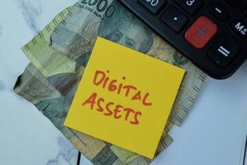 Concept of Digital Assets write on sticky notes isolated on Wooden Table.