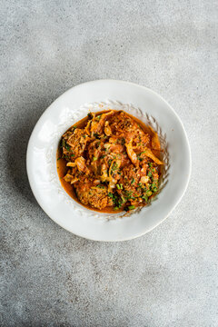 Georgian Gupta dish of meatballs with rice stewed in tomato sauce with cabbage, carrot and onion, served with chopped coria