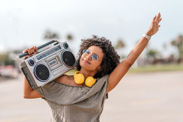 Smiling young woman listening to music with radio