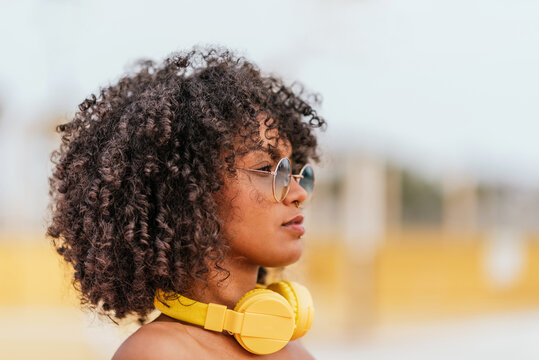 Young Woman With Headphones And Eyeglasses Curly Hairstyle Looking Forward