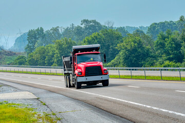 Heavy Duty Red Dump Truck On Hazy Summer Day