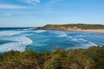 Fototapeta na wymiar Typical western Algarvian landscape. Stormy ocean and lonely beach. Portugal