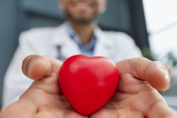 Doctor man holding red heart, Cardiology concept.