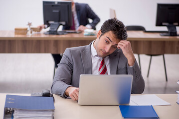 Two male colleagues working in the office