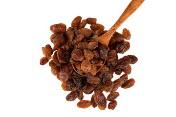 Top view of a bunch of raisins and a spoonful of raisins on a white background.