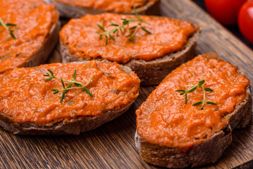 Delicious sandwich consisting of toast, red sauce with salt, spices and herbs