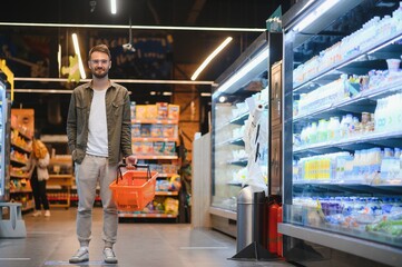 Handsome man shopping in a supermarket
