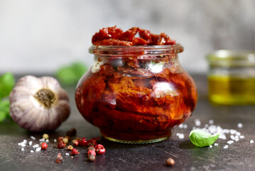 Pickled dried tomatoes in a vintage jar.
