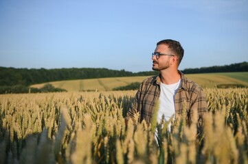 Naklejka na ściany i meble Portrait of farmer in wheat field