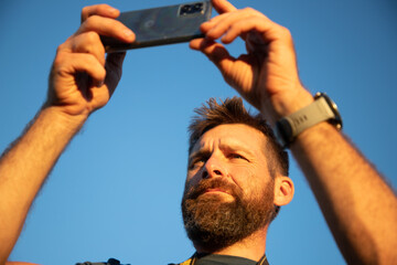 man taking photos with a phone