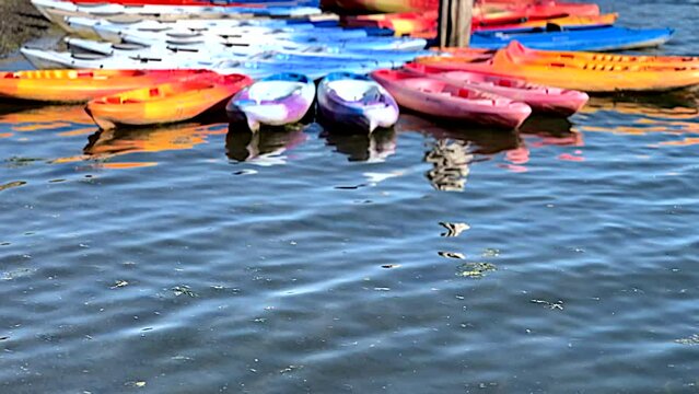 Reflection of Floating Kayaks on the Water