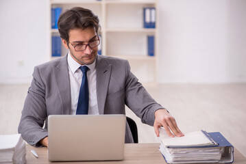 Young male employee working in the office