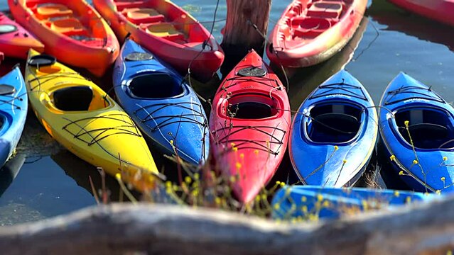 Colorful Kayaks Moored Along Rocky Shore