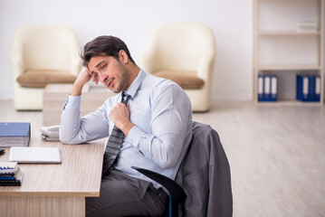 Young male employee working in the office