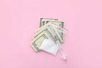 Drugs, syringe and money on pink background
