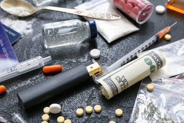 Different drugs, lighter, syringes and money on dark background, closeup