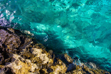 Top view of rocky sea coast and blue water