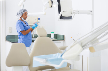 Nurse prepares instruments before the patient is seen by the dentist