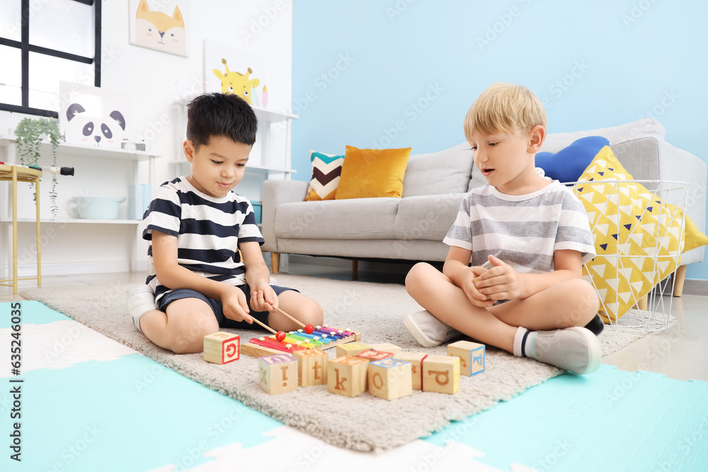 Sticker cute little boys playing with cubes at home