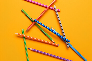 Group of colorful pencils on yellow background