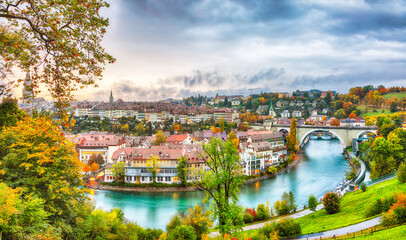 Amazing autumn view of Bern city on  Aare river during evening with Pont de Nydegg bridge and...