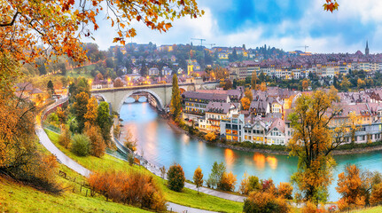 Amazing autumn view of Bern city on  Aare river during evening with Pont de Nydegg bridge and Nydeggkirche - Protestant church