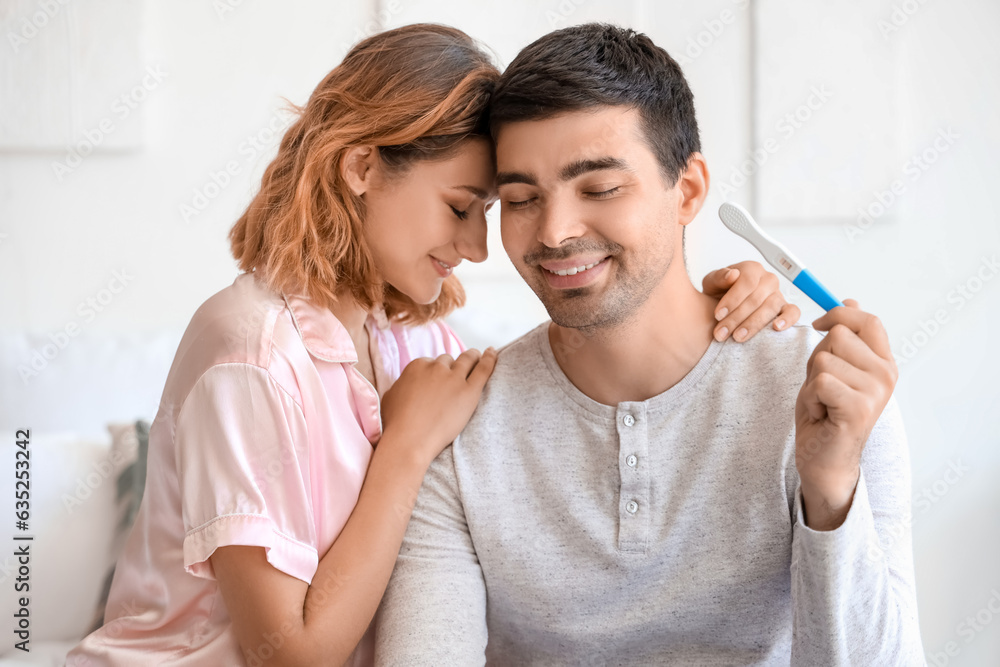 Sticker Happy young couple with pregnancy test in bedroom