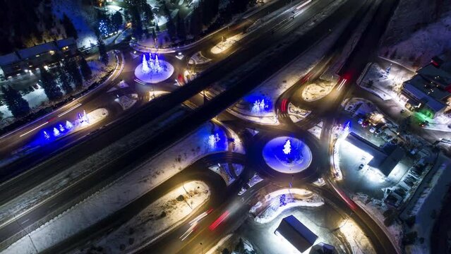 Aerial Panning Shot Of Cars Moving On Bridge With Illuminated Christmas Lights In City During Winter - Vail, Colorado