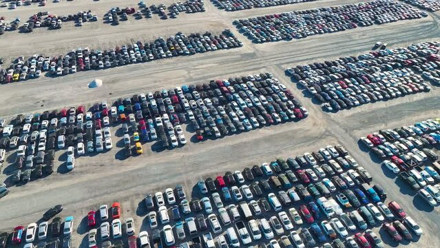 Aerial view of auction reseller company big parking lot with parked cars ready for remarketing services. Sales of secondhand vehicles