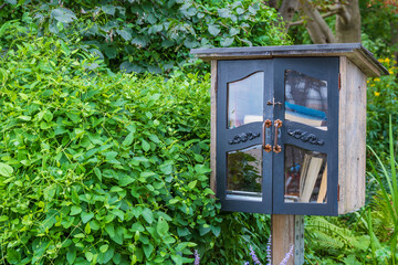 A free book exchange box on a residential street.	