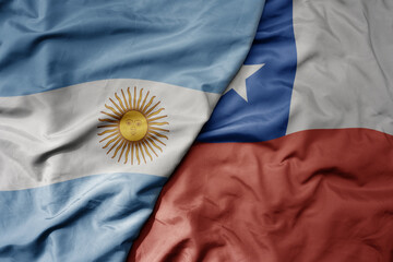 big waving realistic national colorful flag of argentina and national flag of chile .
