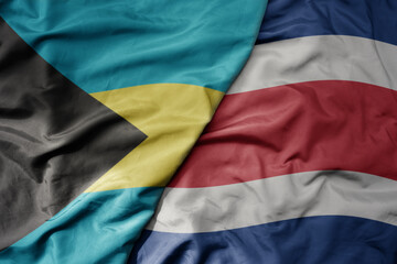 big waving realistic national colorful flag of bahamas and national flag of costa rica .