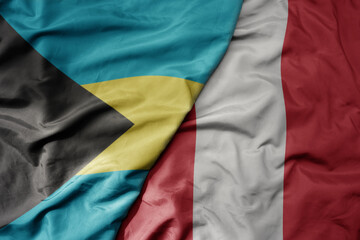 big waving realistic national colorful flag of bahamas and national flag of peru .