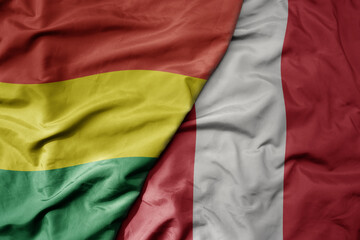 big waving realistic national colorful flag of bolivia and national flag of peru .