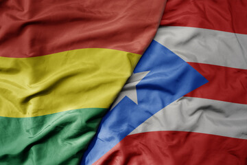 big waving realistic national colorful flag of bolivia and national flag of puerto rico .