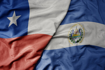 big waving realistic national colorful flag of chile and national flag of el salvador .