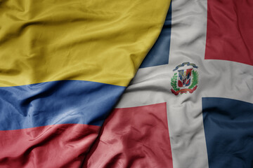 big waving realistic national colorful flag of colombia and national flag of dominican republic .