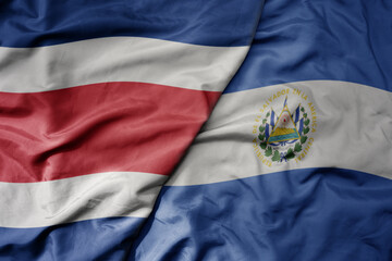big waving realistic national colorful flag of chile and national flag of el salvador .
