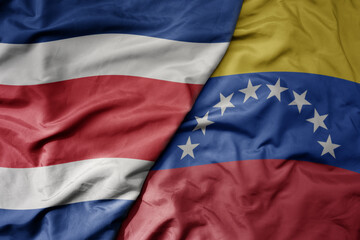 big waving realistic national colorful flag of chile and national flag of venezuela .