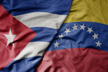 big waving realistic national colorful flag of cuba and national flag of venezuela .